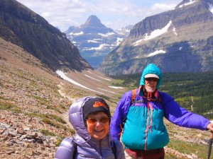 Amy and Rob buffeted by high wind climbing to Siyeh Pass